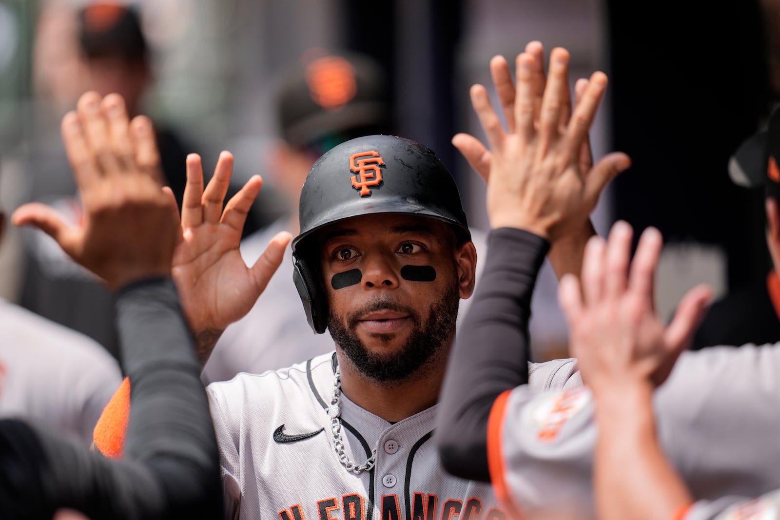 San Francisco Giants' Dominic Smith (7) celebrates scoring off the bat of Luis Matos in the seventh inning of a baseball game, Wednesday, July 23, 2025, in Atlanta. (AP Photo/Mike Stewart)