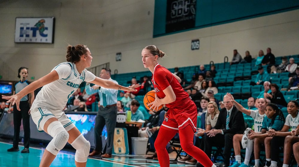 Miami University's Amber Scalia prepares to drive past a Chanticleers defender during their game at Coastal Carolina on Monday, Nov. 3 at The HTC Center. The RedHawks won 63-53. MIAMI ATHLETICS