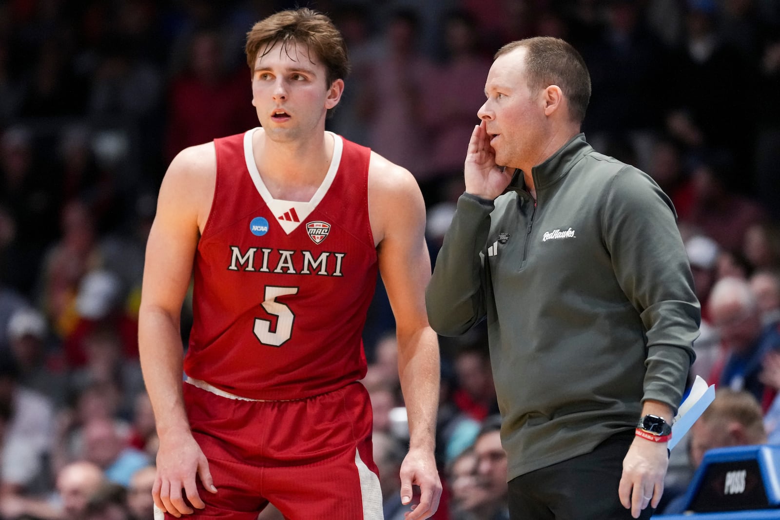 Miami (Ohio) guard Peter Suder (5) speaks with head coach Travis Steele during the second half of a First Four college basketball game against SMU in the NCAA Tournament in Dayton, Ohio, Wednesday, March 18, 2026. (AP Photo/Jeff Dean)