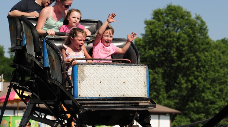 Noelle Dente, left, sits next to Brenna Lowery on a roller coaster at the Hamilton Township Berry Festival in 2012. Hamilton Twp. is the safest locality in the region, according to a trade group study.