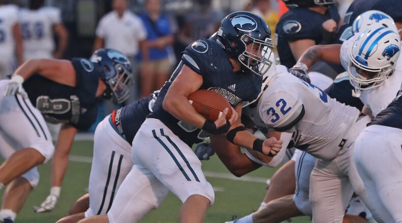 Fairmont's Drew Baker carries the ball against Springboro during Friiday's game. BILL LACKEY/STAFF