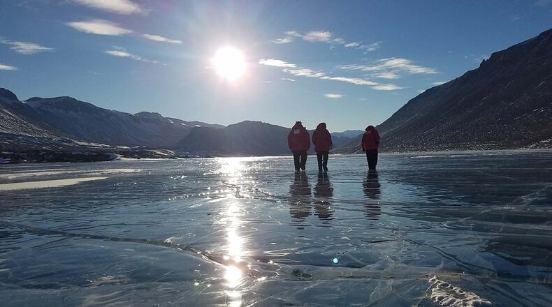 Staff. Sgt. Jeremy Hannah, Senior Airman Andrew Pouncy and Staff Sgt. Justin Sherman, all from the Air Force Technical Applications Center, Patrick Air Force Base, Fla., walk on a frozen lake in Antarctica after a full day of performing maintenance on the center’s seismic equipment near Bull Pass. The photo, taken at about 10 p.m., illustrates the 24-hour daylight cycle at Earth’s southernmost point. (U.S. Air Force photo/Senior Airman Richard Westra)