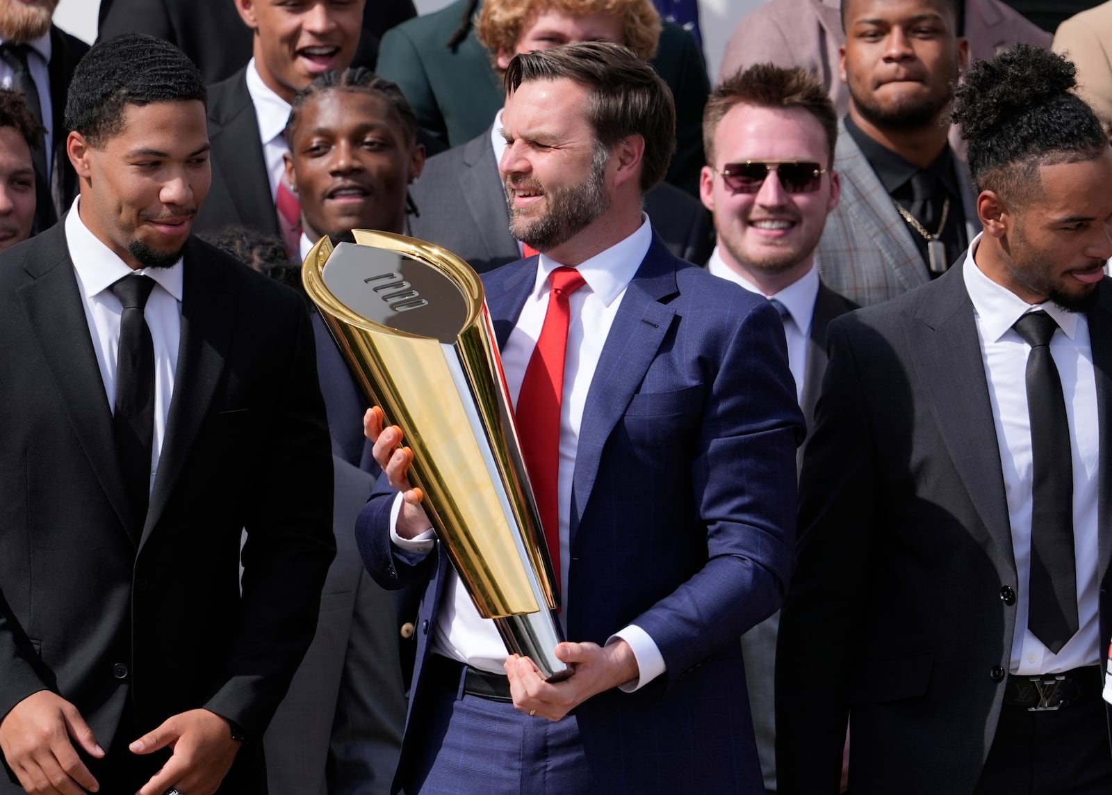 Vice President JD Vance holds the top of the Ohio State University football team's championship trophy after it's base fell off as President Donald Trump welcomes the 2025 College Football National Champions during an event on the South Lawn of the White House, Monday, April 14, 2025, in Washington. (AP Photo/Manuel Balce Ceneta)