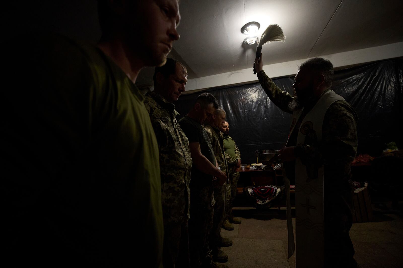 In this photo provided by Ukraine's 93rd Kholodnyi Yar Separate Mechanized Brigade press service, Ukrainian servicemen attend an Easter service on their position in the Donetsk region, Ukraine, Sunday, April 20, 2025. (Mykola Oliinyk/Ukraine's 93rd Mechanized Brigade via AP)