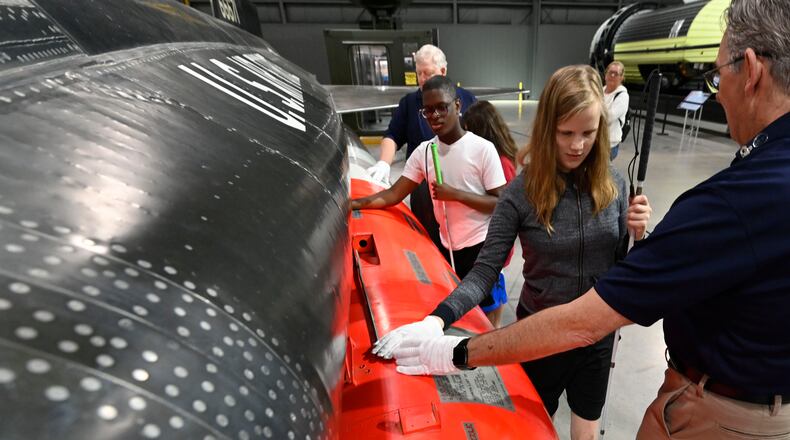 Students from the Ohio State School for the Blind take a touch tour of the National Museum of the U.S. Air Force with guidance from museum volunteers who are trained to conduct the tours. (U.S. Air Force photo by Ty Greenlees)