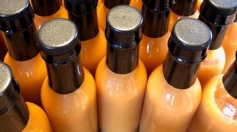 Tracy and Jeffrey McElfresh of Kettering have released JuicyMelt Supreme Hot Sauce.  Varieties include Ruby Wizard (grapefruit habanero), OG Catalyst (orange ginger habanero), and All the Fun (white pepper peach). CONTRIBUTED