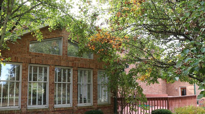 Patio doors from the family room open into a 4-season room with a cathedral ceiling and access to the rear wooden deck and picket-fenced back yard.