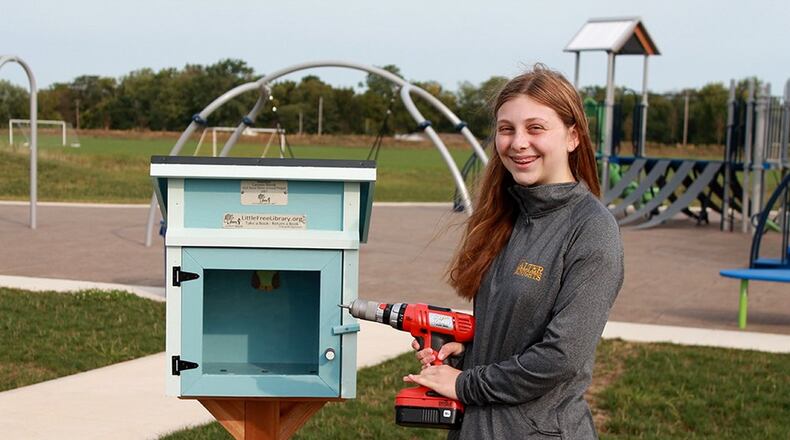Lauren Shenk installing her Little Free Library at Robert F. Mays Park, part of the Centerville-Washington Township Park District. CONTRIBUTED