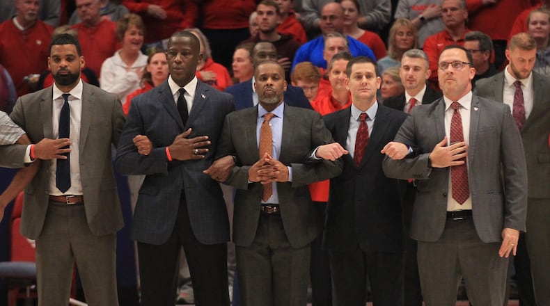 Dayton coaches stand for the national anthem before a game against Grambling State on Monday, Dec. 23, 2019, at UD Arena. From left to right are Ricardo Greer, Anthony Grant, Anthony Solomon, Darren Hertz and Andy Farrell. David Jablonski/Staff