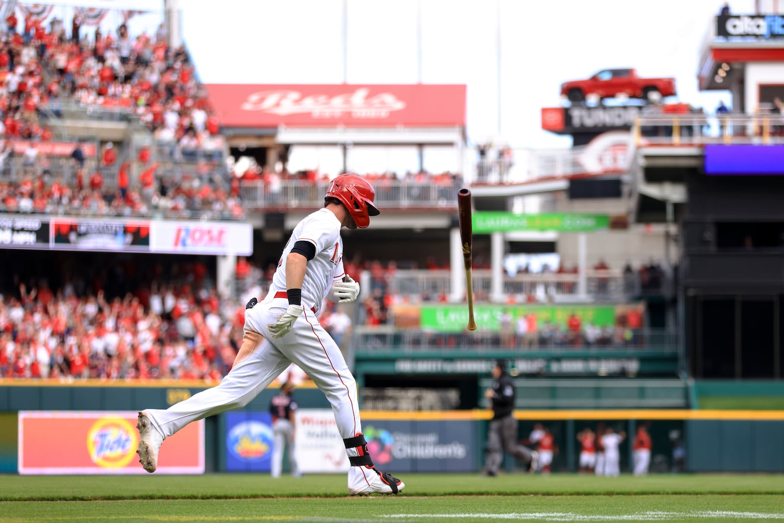 Cincinnati Reds' Tyler Naquin tosses his bat after hitting a two-run home run during the sixth inning of the team's baseball game against the Cleveland Guardians in Cincinnati, Tuesday, April 12, 2022. (AP Photo/Aaron Doster)