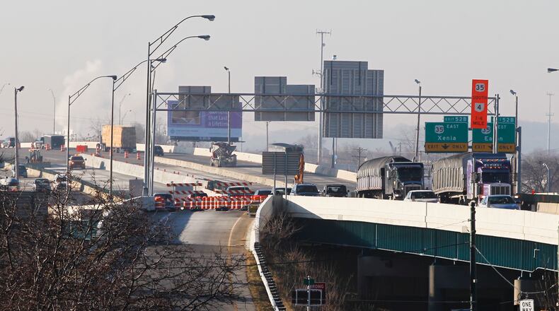 The Ohio Department of Transportation said Wednesday morning that it postponed a “big flip,” when all southbound traffic, seen Wednesday morning in the far lanes, would be switched to the northbound lanes on Interstate 75 through downtown Dayton. ODOT spokeswoman Mandi Abner said cold temperatures prevented the “flip” overnight. CHRIS STEWART / STAFF