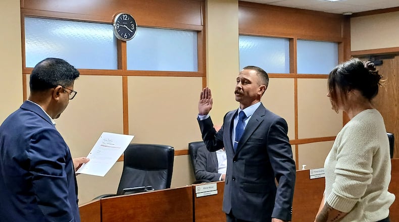 Guy Aber was sworn-in by Montgomery County Board of Elections Member Mohamed Al-Hamdani during a board meeting on Tuesday, Sept. 9, 2025. He was joined by his wife, Brittany. STAFF/SYDNEY DAWES