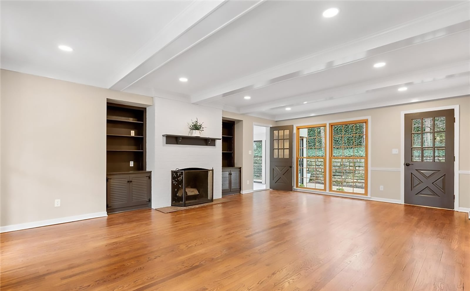 The family room is off the foyer and has two built in bookcases flanking a woodburning fireplace with gas starter, recessed lighting and refinished hardwood floors. CONTRIBUTED