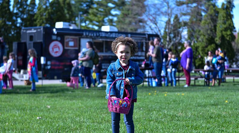 Jada Angel, fills her basket with eggs from the Easter egg hunt on April 15 at Turtle Pond on Wright-Patterson Air Force Base. The 88th Force Support Squadron held an Easter egg hunt for military, civilian personnel and their families. U.S. AIR FORCE PHOTO/SENIOR AIRMAN JACK GARDNER