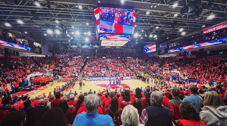 Dayton and Virginia Commonwealth stand for the national anthem before a game on Friday, March 8, 2024, at UD Arena. David Jablonski/Staff