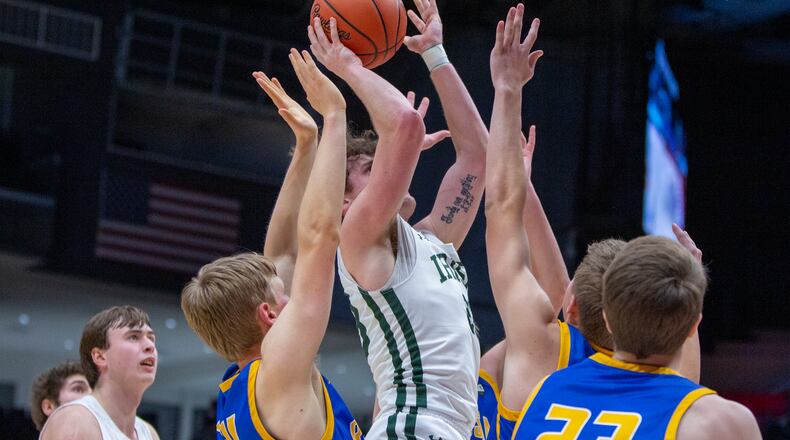 Catholic Central's Cole Ray shoots in a crowd of Russia defenders during Tuesday night's Division IV district final at UD Arena. Russia won 70-58. CONTRIBUTED/Jeff Gilbert