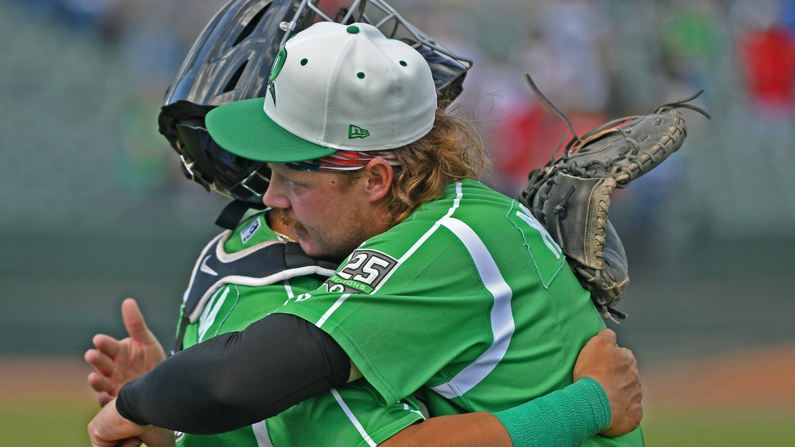 Pitcher Joseph Menefee and catcher Diego Omana embrace after the Dragons won their final game on Sunday at Day Air Ballpark. JEFF GILBERT/CONTRIBUTED
