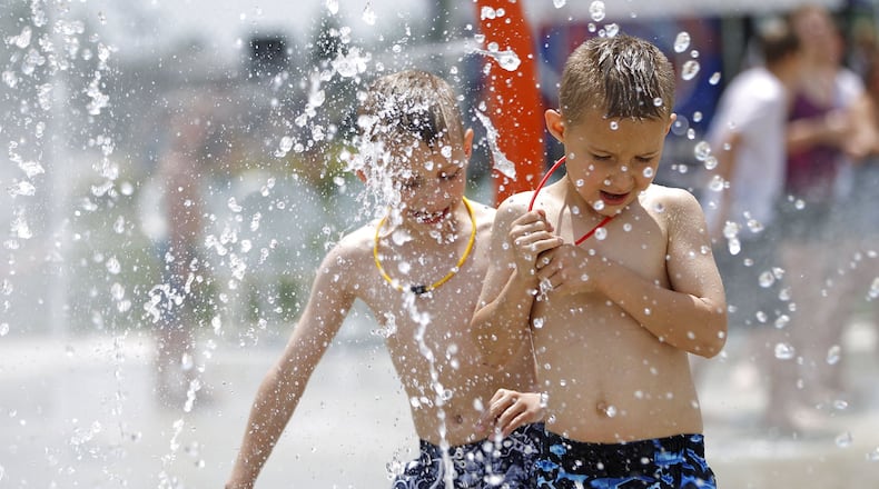Brothers Logan and Ethan Judy enjoyed the Kroger Aquatics Center at The Heights on a warm Tuesday afternoon. The parking lot of the water park was almost full by noon. TY GREENLEES / STAFF