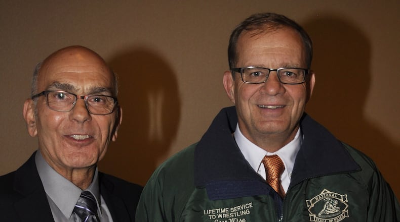 Stamat Bulugaris (left), now a Beavercreek middle school wrestling coach, and Beavercreek coach Gary Wise during Wise’s induction into the National Wrestling Hall of Fame Ohio Chapter at Columbus this fall. CONTRIBUTED PHOTO