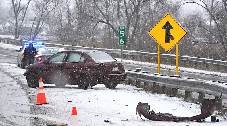 A car slides into a guardrail along northbound I-75 near Stanley Avenue Monday morning, February 15, 2021. MARSHALL GORBY/STAFF