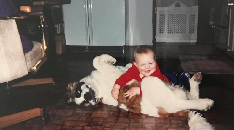 Two-year-old Wes Martin plays with his St. Bernard, Heidi. CONTRIBUTED