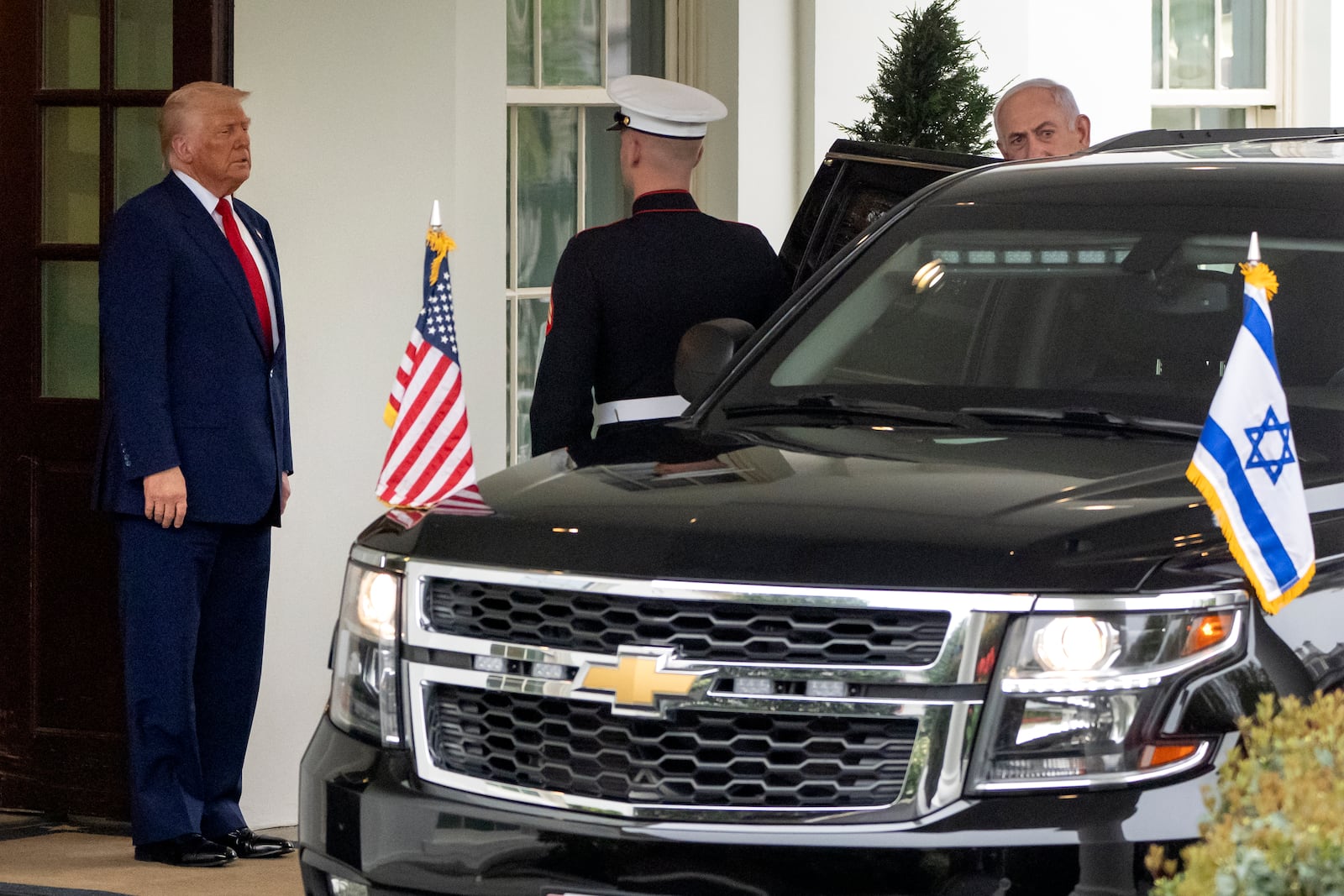 President Donald Trump, left, watches as Israel's Prime Minister Benjamin Netanyahu gets in a vehicle as he leaves the West Wing of the White House, Monday, April 7, 2025, in Washington. (AP Photo/Mark Schiefelbein)
