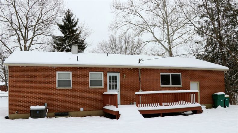 A door from the kitchen opens to the wooden deck and another doorway leads to the basement stairwell.