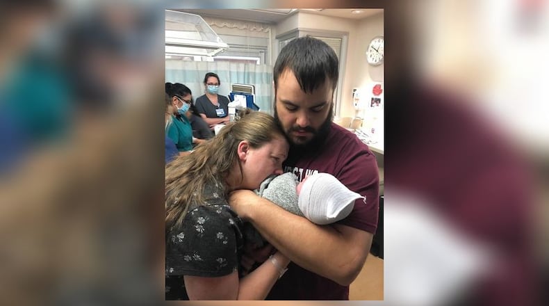 Jeremy and Liz Lovy comfort their son, Logan, after he died Sept. 15, 2021 at Miami Valley Hospital in Dayton. SUBMITTED PHOTO