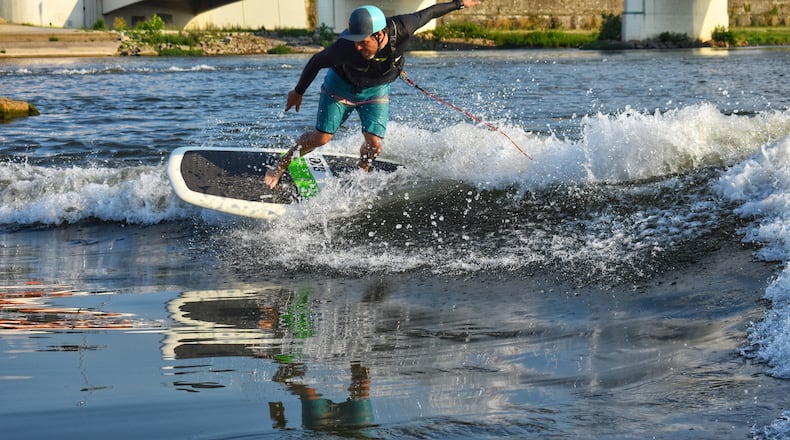 Shannon Thomas of Surf Dayton enjoys surfing the Art Wave in downtown Dayton. CONTRIBUTED