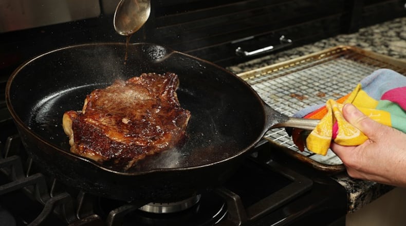The steak cooks low and slow, at 225 degrees, in the oven until the middle reaches 110 degrees. Then it's browned in a hot skillet, while being basted with butter to help promote the browning. (Chris Walker/Chicago Tribune/TNS)