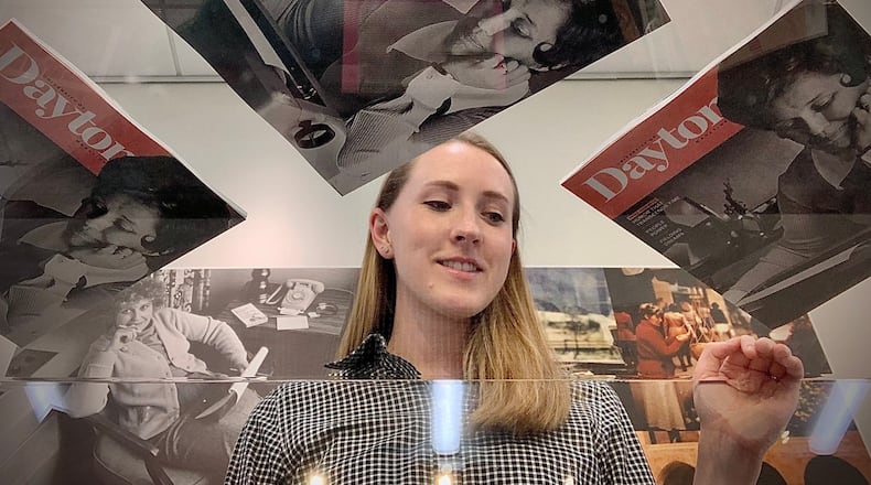 Katie Jarrell, project archivist at the University of Dayton, looks over the Erma Bombeck Collection at the UD library. A photo of Bombeck is on the cover of the University of Dayton Magazine. The collection will be on display until October 23, 2022. MARSHALL GORBY \STAFF