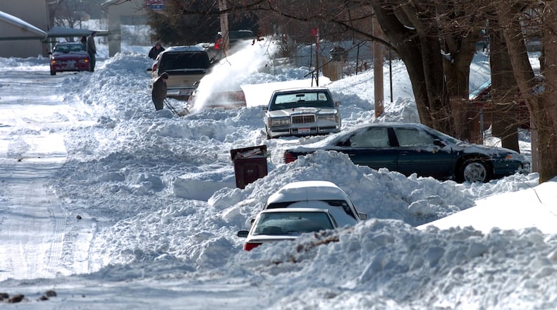 People still try to dig themselves out on Superior Avenue Friday morning, Dec. 24, 2004, after the record-breaking snow that began Dec. 22. Also see: FRONT PAGES | Storm by the numbers