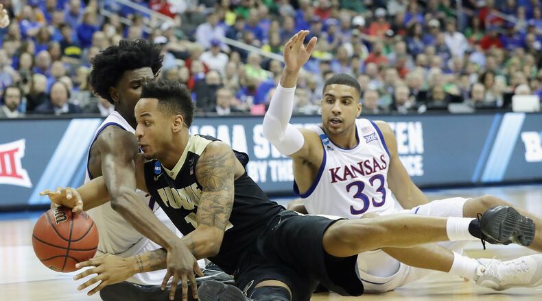 KANSAS CITY, MO - MARCH 23: Josh Jackson #11 of the Kansas Jayhawks and Vince Edwards #12 of the Purdue Boilermakers battle for a loose ball in the second half during the 2017 NCAA Men’s Basketball Tournament Midwest Regional at Sprint Center on March 23, 2017 in Kansas City, Missouri. (Photo by Ronald Martinez/Getty Images)
