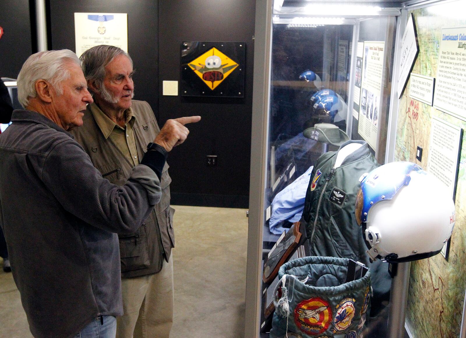 Aviation legends Dick Rutan, left, and his brother Burt Rutan, toured the National Museum of the U.S. Air Force on Thursday.  Both men visited aircraft that were significant parts of their careers including this Misty FAC display in which Dick Rutan has artifacts from Vietnam.  TY GREENLEES / STAFF