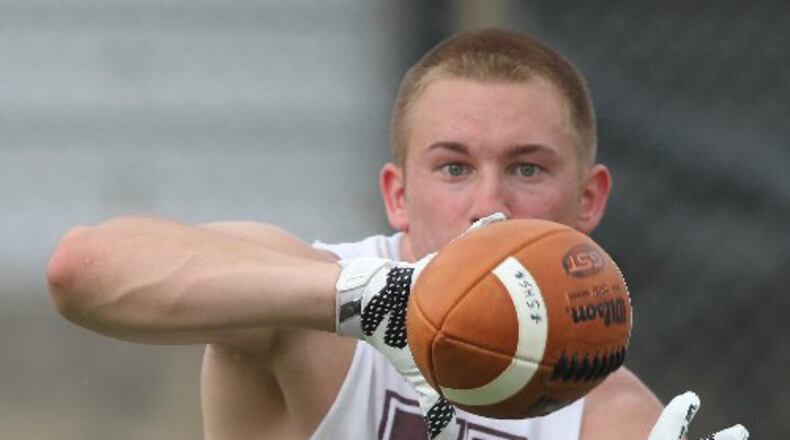 Urbana junior Adam Gaver catches a pass at a Michigan satellite camp at Springfield High School last summer. David Jablonski/Staff