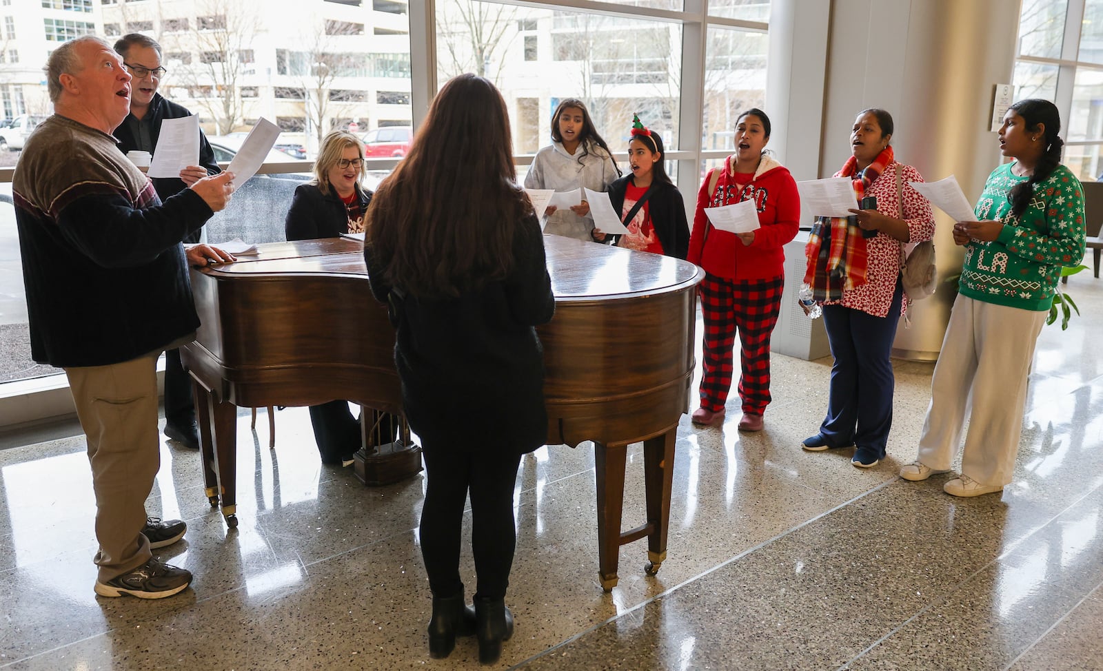 A group organized by Scott Davidson sings carols on Monday, Dec. 22 at Miami Valley Hospital in Dayton with a group organized by Scott Davidson. The group also sang at Miami Valley Hospital North and South on Monday. BRYANT BILLING/STAFF