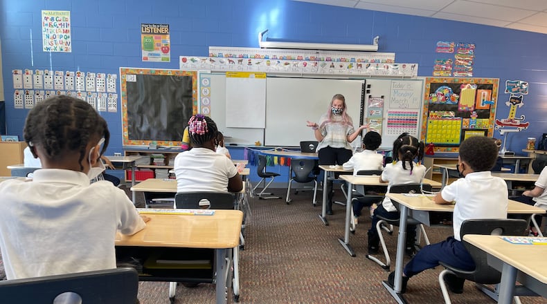 A Fairview Elementary teacher welcomes students back to school and reviews COVID-19 protocols with them before beginning class on March 1. Approximately 75% of Dayton Public Schools students returned for in-person instruction in March, with the rest choosing to stay online. CONTRIBUTED PHOTO