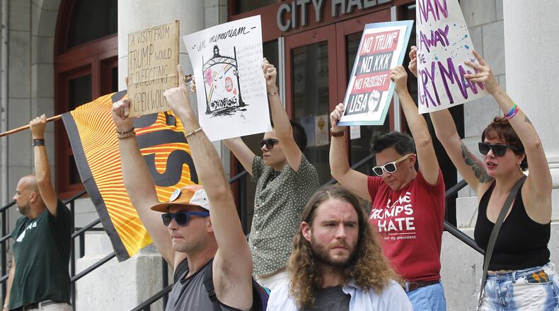 Protesters gathered at Dayton City Hall on Tuesday to voice their opposition to President Trump’s planned visit to Dayton on Wednesday. TY GREENLEES / STAFF