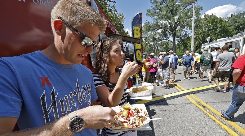 Chase and Della Rice enjoy nachoes from a BBQ food truck at the Springfield Rotory Food Truck Competition at Veteran’s Park earlier this year. The fourth annual Local Food Summit will be held Nov. 4. Bill Lackey/Staff