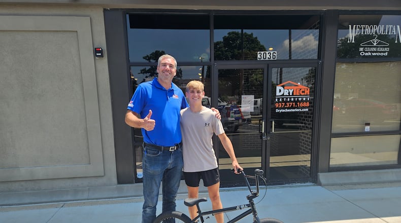 Brad Hosler, left. with Jonah Shreves and his new bike. JESSICA GRAUE/CONTRIBUTED