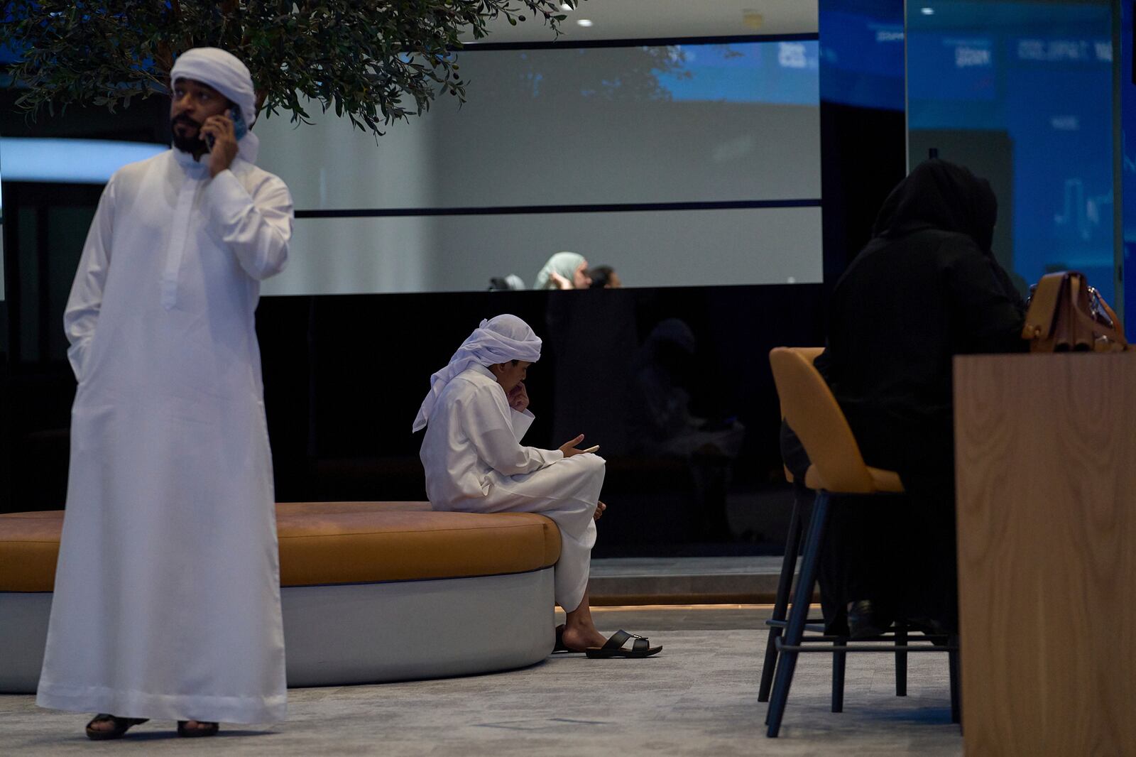 Emiratis are seen in the Dubai Financial Market in Dubai, United Arab Emirates, Monday, April 7, 2025. (AP Photos/Fatima Shbair)