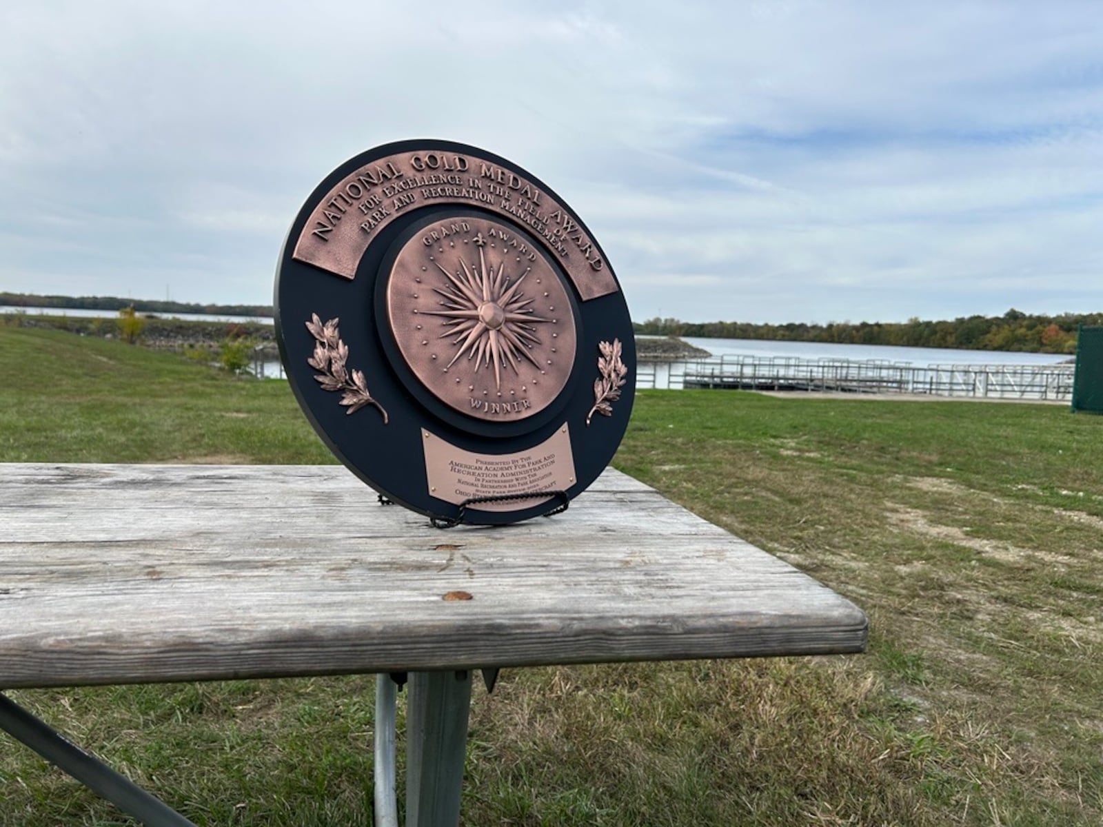 Ohio's gold medal for number one state park system in the country is displayed on a table at Buck Creek State Park in Springfield Friday, Oct. 17. 2025. JESSICA OROZCO/STAFF