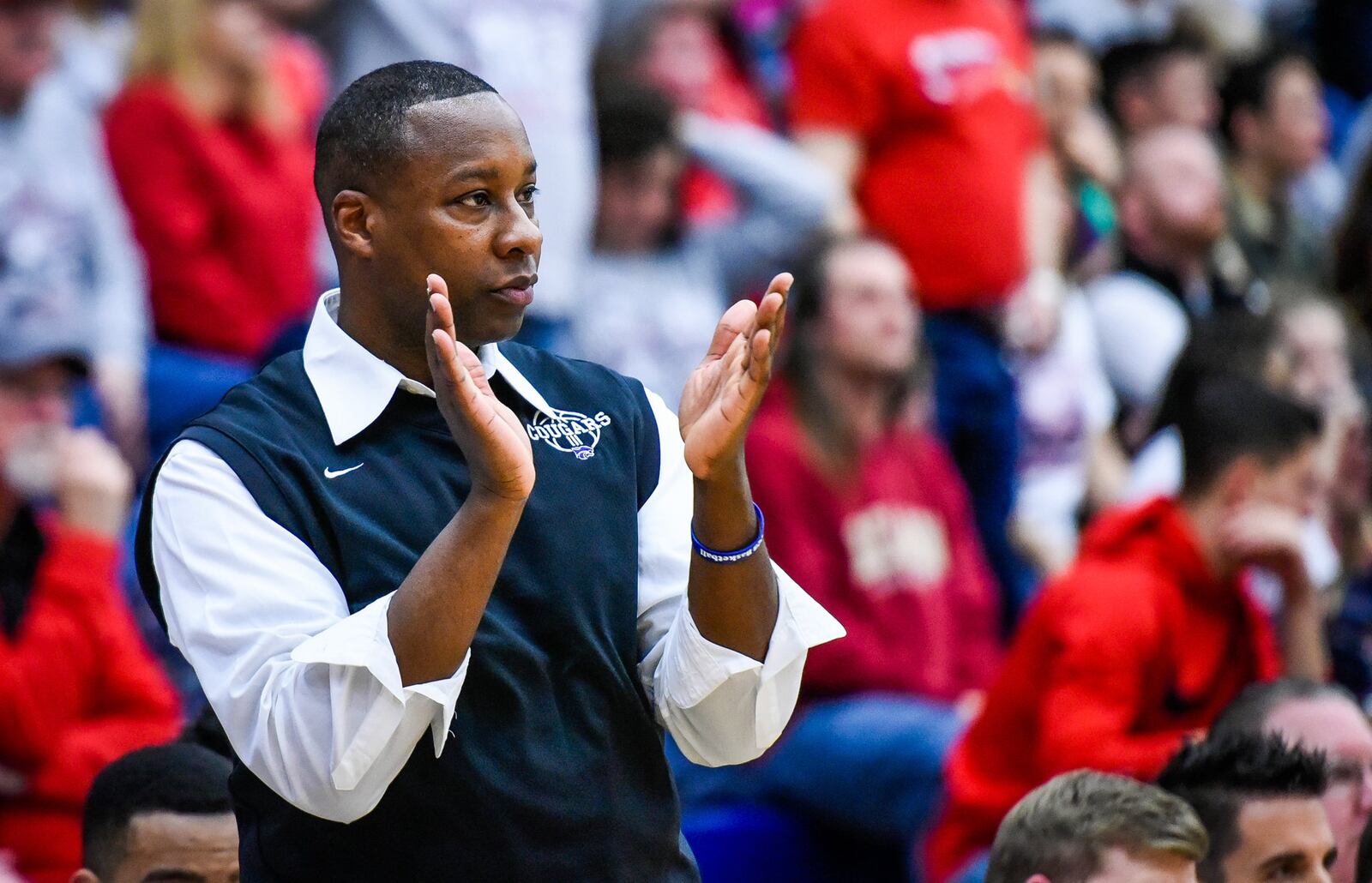 Cincinnati Christian coach Carl Woods cheers on his team during their 57-44 loss to Lima Perry in a Division IV regional final March 17 at Fairmont’s Trent Arena. NICK GRAHAM/STAFF
