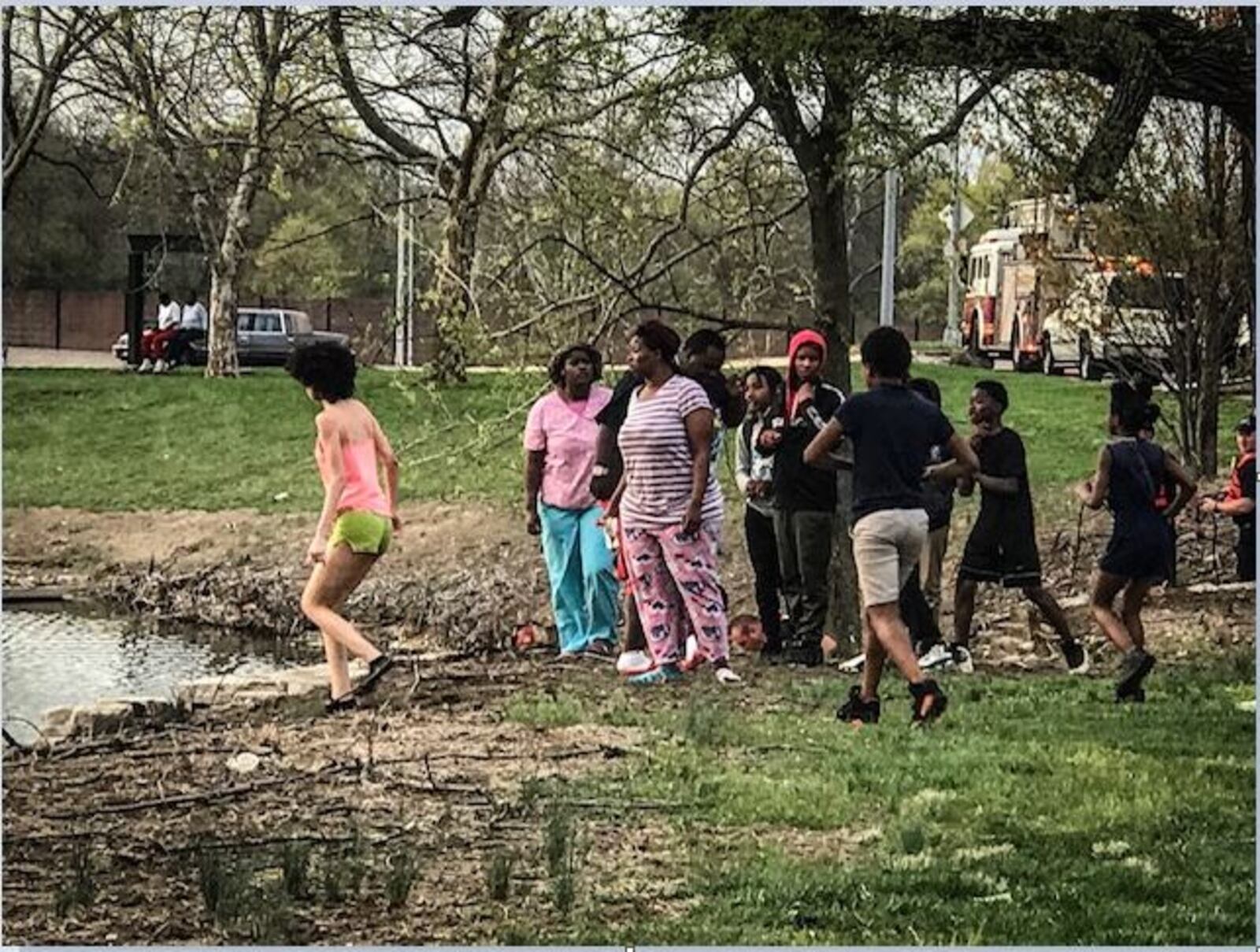 This woman ran and jumped into a pond Thursday evening as Dayton fire/rescue crews were investigating a possible drowning at Lakeside Park (Jim Noelker/Staff)