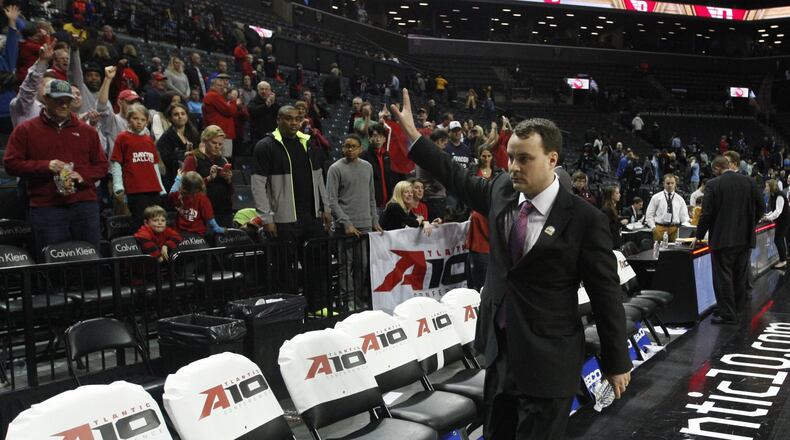 Dayton coach Archie Miller waves to the fans as he leaves the court after a victory against Rhode Island in the semifinals of the Atlantic 10 tournament on Saturday, March 14, 2015, at the Barclays Center in Brooklyn, N.Y. David Jablonski/Staff