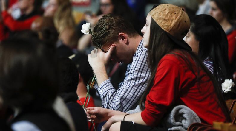 Students Tanner Hale, center, and Kayla Croyle attend a vigil following an attack at The Ohio State University campus the previous day, Tuesday, Nov. 29, 2016, in Columbus, Ohio. Investigators are looking into whether a car-and-knife attack at Ohio State University that injured several people was an act of terror by a student who had once criticized the media for its portrayal of Muslims. (AP Photo/John Minchillo)