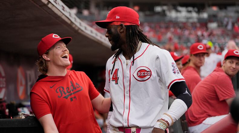 Cincinnati Reds pitcher Andrew Abbott, left, and shortstop Elly De La Cruz celebrate in the dugout as it was announced that Abbott will join De La Cruz as the Reds' representatives for the 2025 Major League Baseball All-Star Game, during the fourth inning of a baseball game against the Miami Marlins in Cincinnati, Tuesday, July 8, 2025. (AP Photo/Carolyn Kaster)
