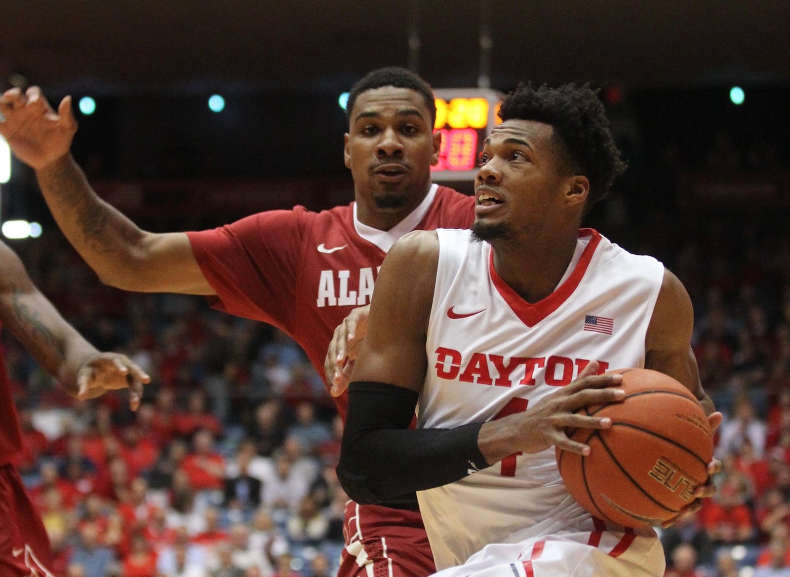 Dayton’s Charles Cooke drives to the basket against Alabama’s Jimmie Taylor on Tuesday, Nov. 17, 2015, at UD Arena in Dayton. David Jablonski/Staff