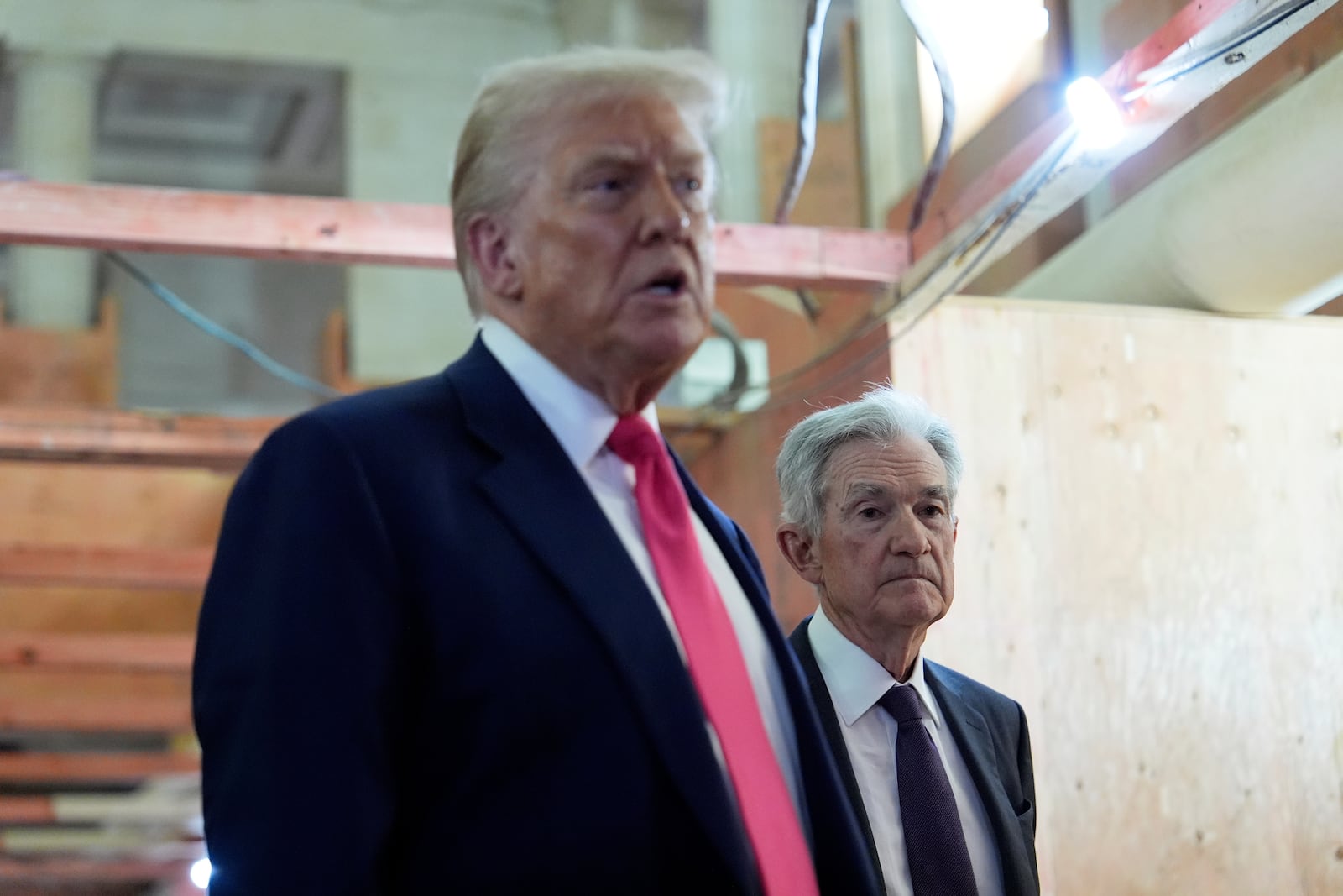 Federal Reserve Chairman Jerome Powell listens as President Donald Trump speaks during a visit to the Federal Reserve, Thursday, July 24, 2025, in Washington. (AP Photo/Julia Demaree Nikhinson)