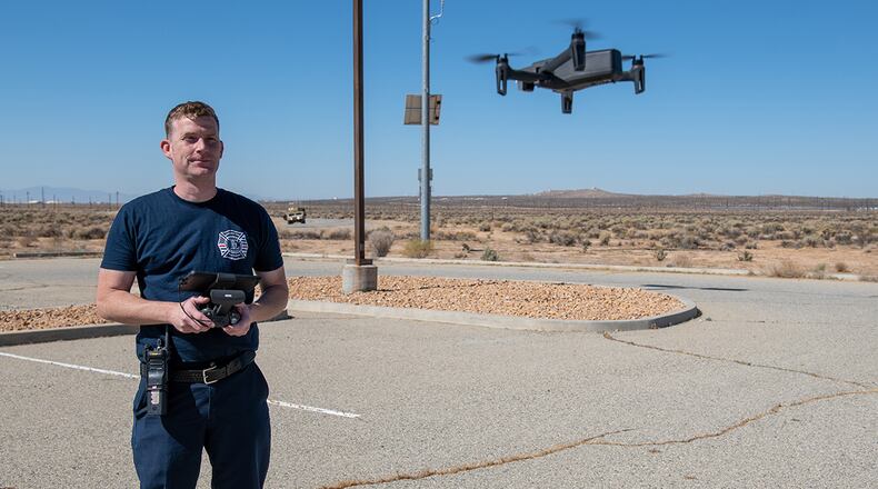 Alan Leckie, lead firefighter, 812th CES, pilots a small unmanned aircraft system during an 812th CES interoperability exercise on North Base at Edwards Air Force Base, California. U.S. AIR FORCE PHOTO/GRADY FONTANA